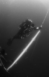 A Nova Scotia Tech Diver waits out his decompression on a... by Michael Grebler 